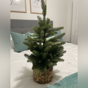 Lowe’s Green Holiday Tree in Woven Basket